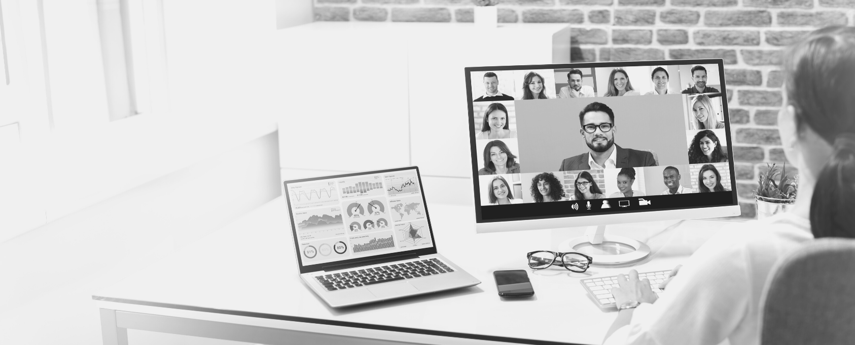 Desktop computer with virtual meeting on the screen.